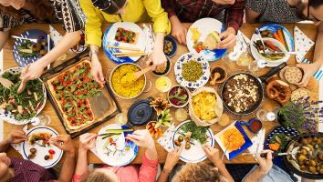 tafel waar groep mensen plantaardig eet