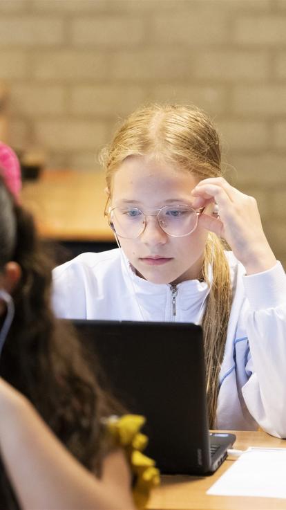 meisje wekt op school aan een schoolopdracht