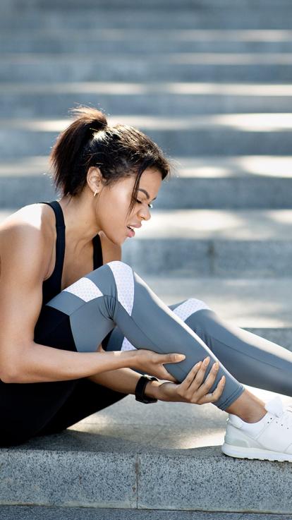 vrouw spierpijn buiten kuit sportief