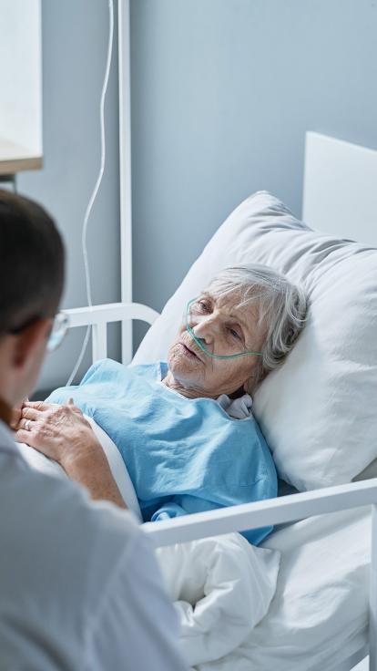 Vrouw in ziekenhuisbed in blauwe operatiekleding