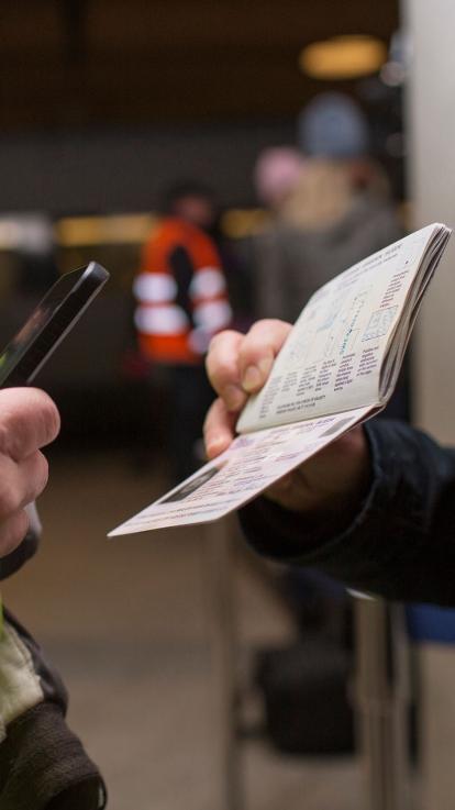 Vrouw houdt paspoort vast die wordt gescand 