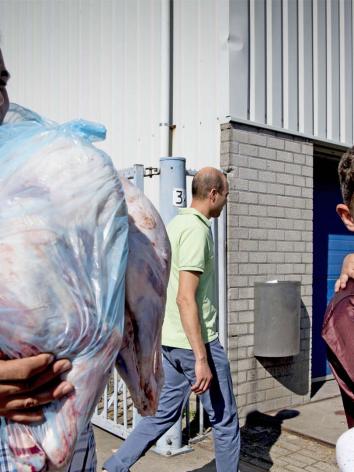 Tijdens het Offerfeest houdt een man een zak met vlees vast