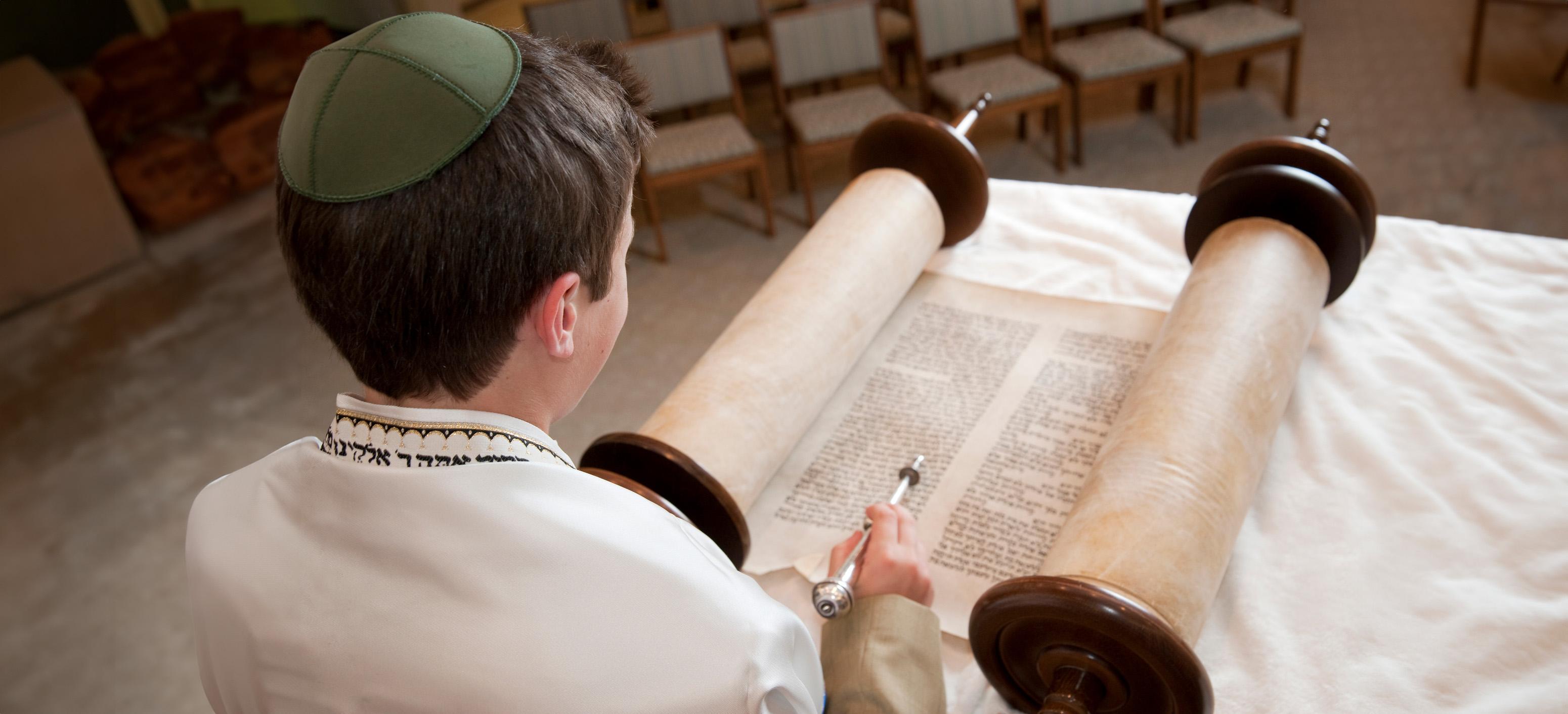 een jongen leest de Tora voor zijn Bar Mitzvah
