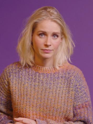 presentator Janouk Kelderman naast een kaart van Jeruzalem na 1948