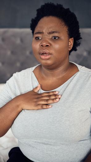 een vrouw met haar hand op de borst