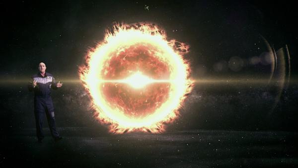 André Kuipers naast een weergave van de zon