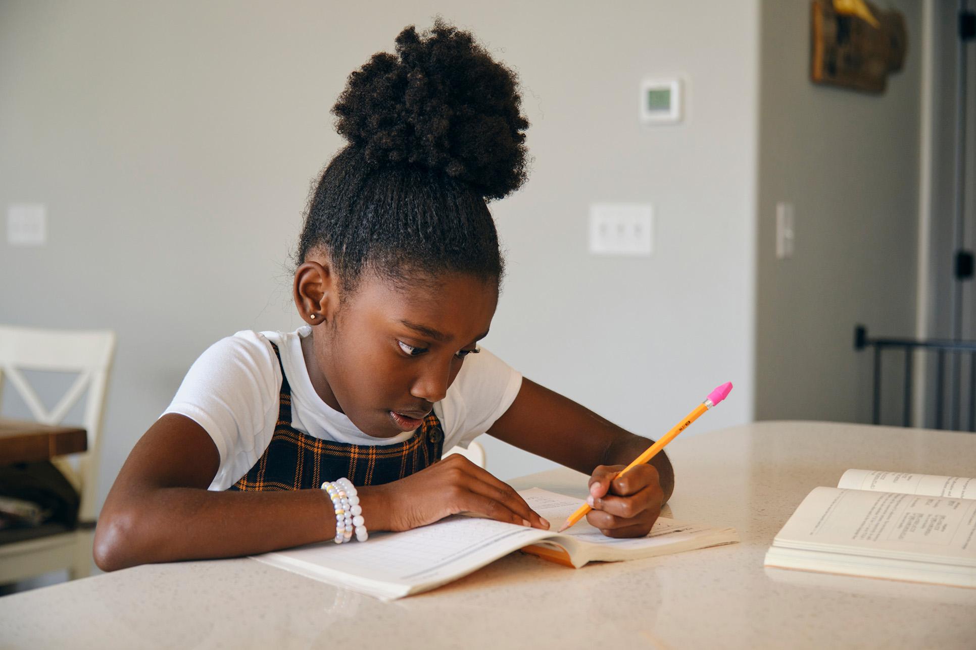 Meisje schrijvend aan tafel