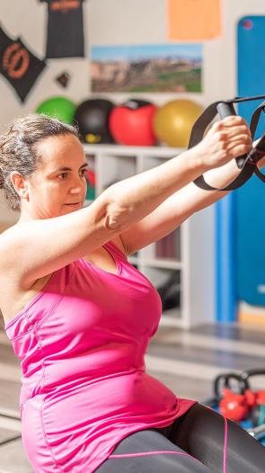 drie mensen volgen een groepsles in een fitnesszaal