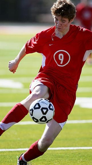 iemand aan het voetballen op een grasveld