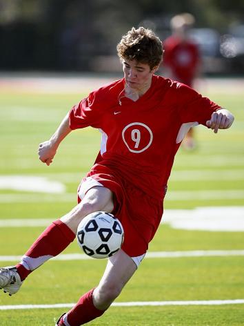 iemand aan het voetballen op een grasveld