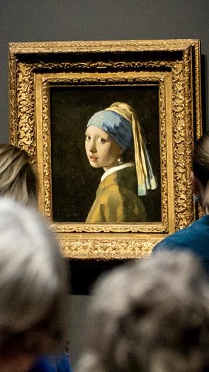 Mensen bekijken het schilderij Meisje met de Parel van Vermeer