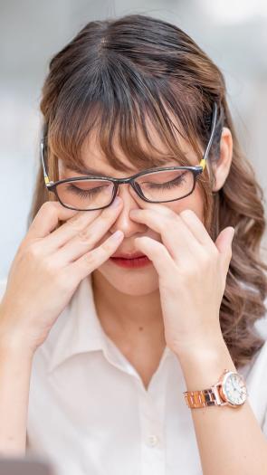 een vrouw wrijft in haar ogen 