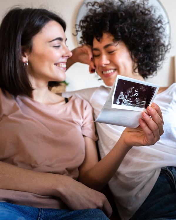 een stel met een echofoto van hun baby