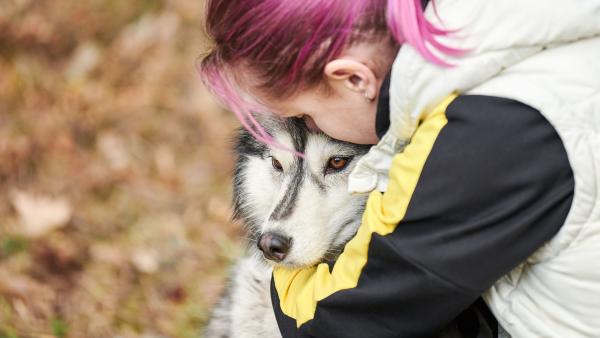 een vrouw knuffelt met haar hond