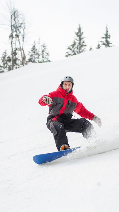 Een foto van een snowboarder die de berg afdaalt
