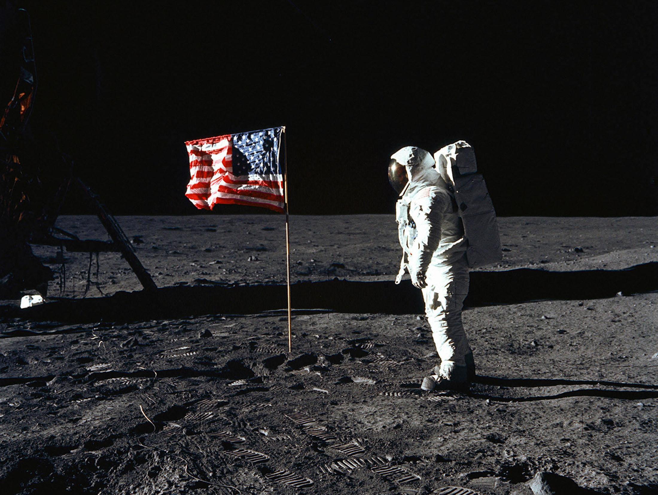 De Amerikaanse astronaut Edwin E. Aldrin jr. op de maan in 1969, naast een Amerikaanse vlag.