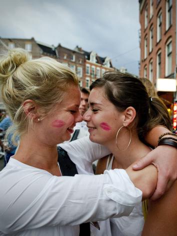Twee vrouwen kussen bijna op straat